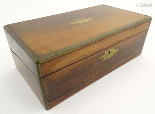 A 19thC writing box, of rosewood and mahogany construction with brass furniture. The lid opening