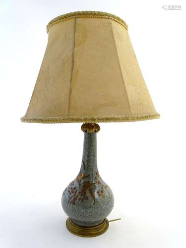 Lighting: an early-to-mid 20thC Oriental table lamp, with brass fitments and base, the ceramic