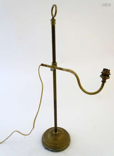 Lighting: an early-20thC brass table lamp, the arm adjustable for height and angle, standing on a