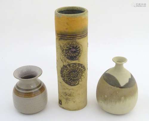 Three studio pottery vases, a tall hand built vase with cut and incised roundel decoration, by Bob