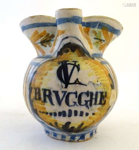 A 19thC Continental faience / tin glaze jug with a pinch spout, decorated with a roundel inscribed