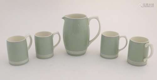 A mid 20thC Keith Murray Wedgwood lemonade / beer set, comprising a moonstone jug and four tankards,