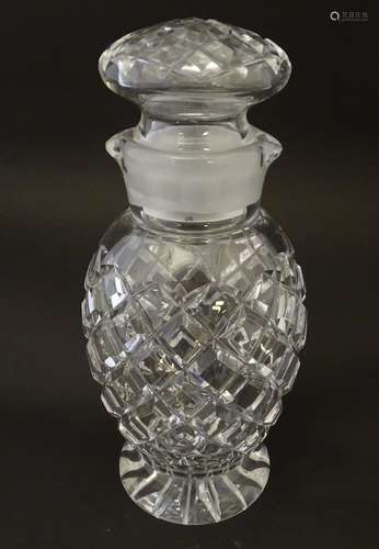 Glass: a 20thC cut crystal decanter, decorated with star, hobnail and block cuts, the next with dual