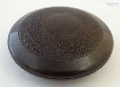 A 20thC circular mottled brown Bakelite tobacco container with screw lid. The base marked