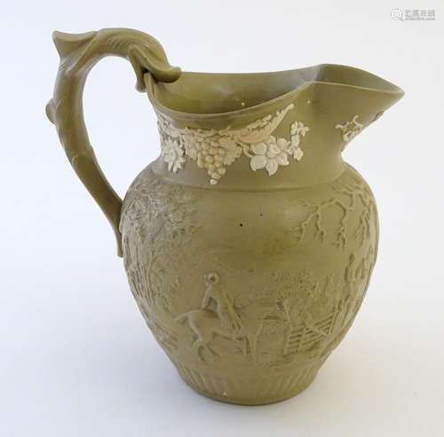 A 19thC jug with relief decoration depicting a hunting scene, with figures, horses, dogs, etc in a