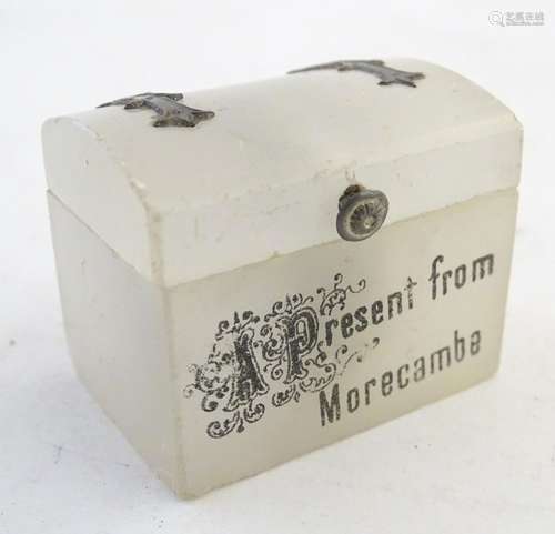 A 20thC soapstone thimble holder formed as a chest with white metal mounts. Marked A present from