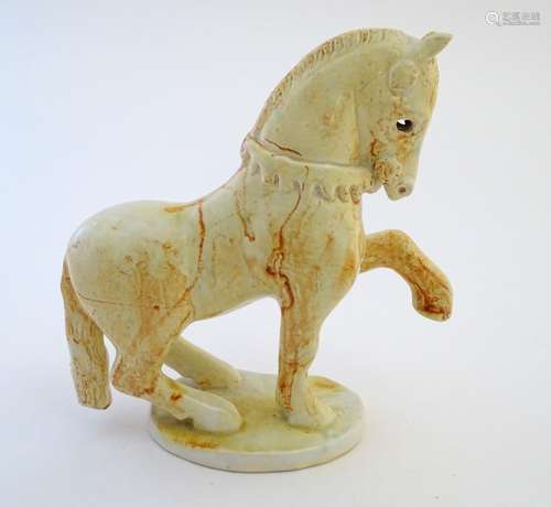 A Paula Humphries studio pottery model of a horse on an oval base. Marked under with impressed bee