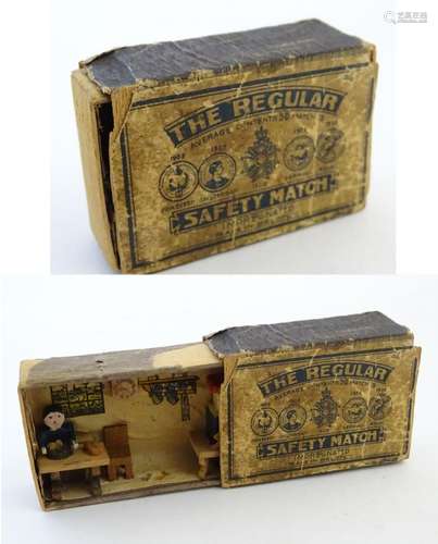 An early 20thC / WWI matchbox diorama, opening to reveal an interior scene with a man seated at a