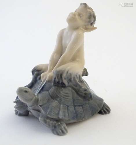 A Royal Copenhagen figure of a faun riding a tortoise, model no. 858, designed by Christian Thomsen.