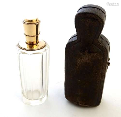 A 19th / 20thC Continental facet cut scent bottle with a 9ct gold top. Contained within a fitted