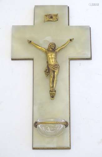 An early 20thC onyx crucifix with a mounted gilt metal Corpus Christi and a small glass holy water