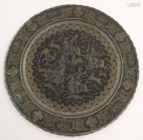 A 19thC Indian / Moghal charger with embossed decoration depicting a hunting scene with figures on