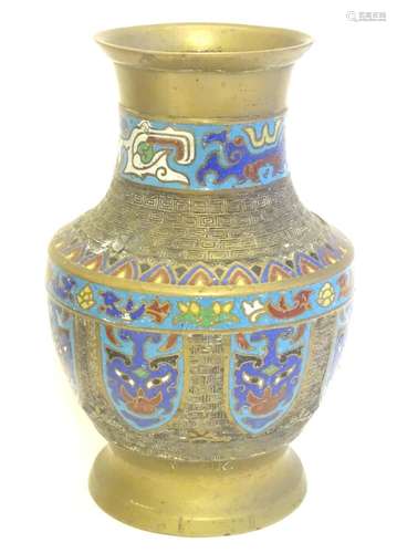 A Japanese brass vase of baluster form with Cloisonné mask and shield decoration to sides. Approx. 9