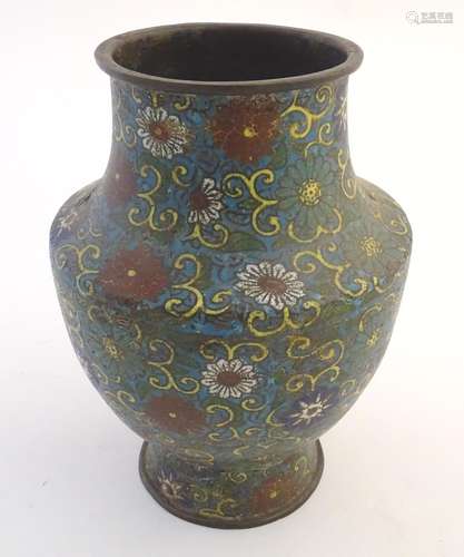 A 19th / 20thC oriental cloisonne enamel vase of baluster form with scrolling floral and foliate