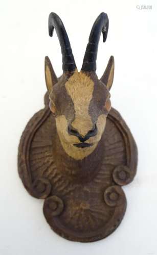 A 20thC carved wooden figure of a chamois deer head on a scrolling quatrefoil mount. Approx. 4 1/