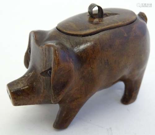 Treen: A 19thC carved wooden snuff box formed as a pig. Approx. 2