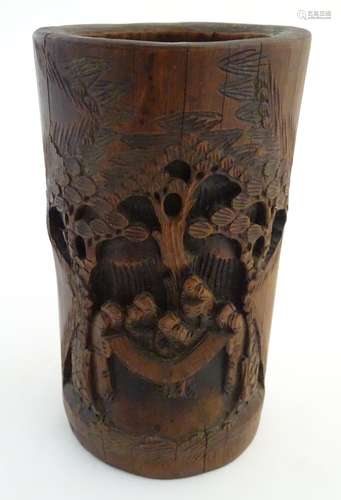 A large bamboo brush pot with carved decoration depicting Oriental figures in a landscape with