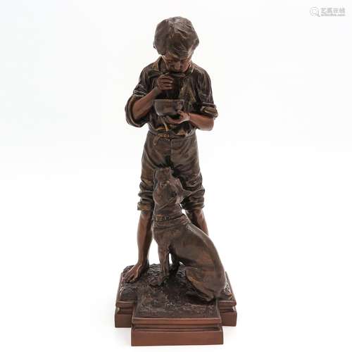 A Sculpture of Boy with Dog