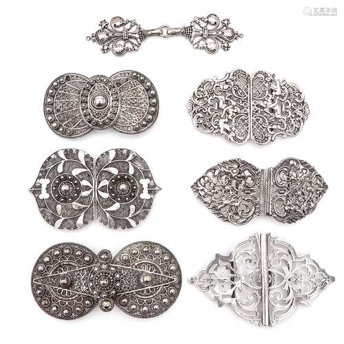 A Collection of Seven Apron Clasps