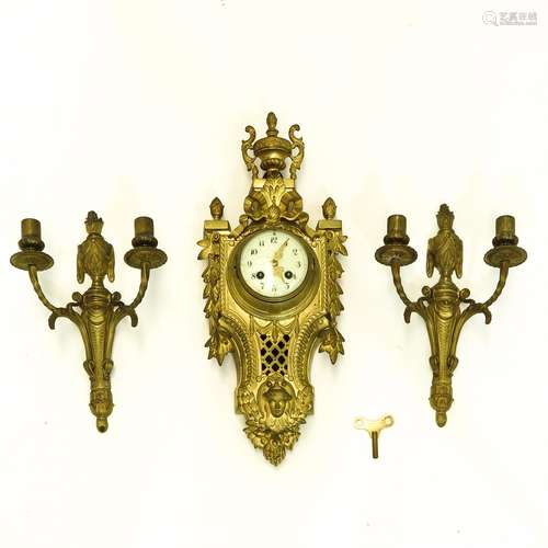 A Cartel Clock and Two Wall Sconces