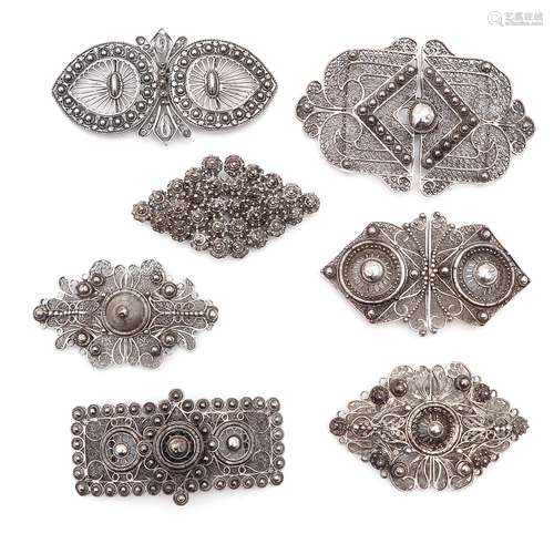 A Collection of Seven Silver Apron Clasps