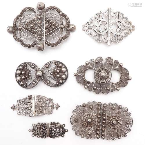 A Collection of Seven Silver Apron Clasps