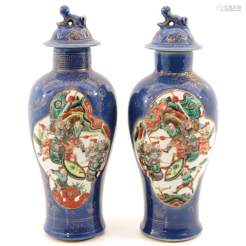 A Pair of Powder Blue and Gilt Vases with Cover