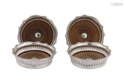 A set of four George III sterling silver wine coasters, Sheffield 1807 by Samuel Kirby & Co