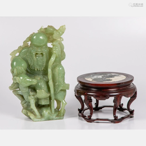 A Chinese Carved Celadon Jade Figural Group D…