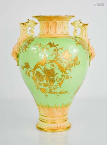 A Royal Worcester twin handled vase, with green ground and gilded decoration. 27cms