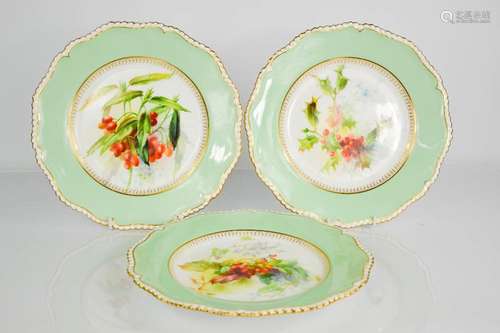 Three Royal Worcester plates by Frank Robert, decorated with flowers, with green boarder and