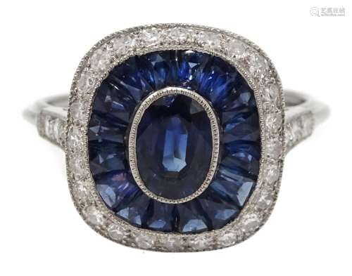 Platinum sapphire and diamond ring, the central oval sapphire surrounded by halo of calibre cut sap