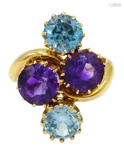 Edwardian 18ct gold four stone blue zircon and amethyst crossover ring, makers mark HPH, Birmingham