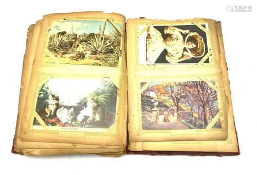 Early 20th century album containing over one hundred and eighty Edwardian and later postcards inclu