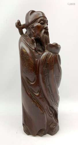 A carved Chinese hardwood figurine, modelled as a sage, H41cm.