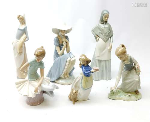 A group of Spanish figurines, to include examples bv Lladro and Nao.