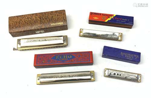 A group of four cased Harmonicas, comprising a Hohner 64 Chromonica, a Hohner Echo, a Hohner Song Ba