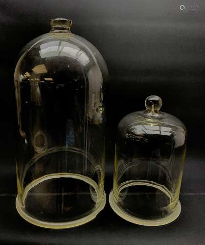 Two Victorian glass cloches, the largest H44cm (a/f), smaller H28cm.