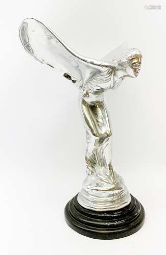 A cast Rolls Royce Spirit of Ecstasy car mascot, raised upon a circular stepped wooden base, H36cm.