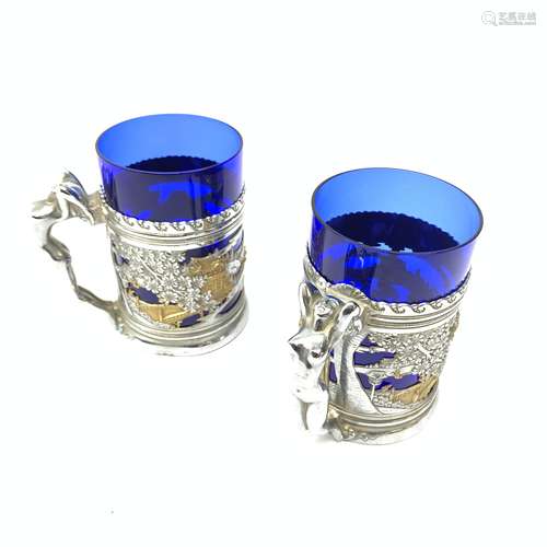 A pair of chromium plated mugs, the bodies detailed with pierced Chinoiserie bands, leading to figu