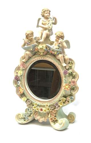 A late 19th century Sitzendorf porcelain mirror, the mirror plate of circular form set within a sha