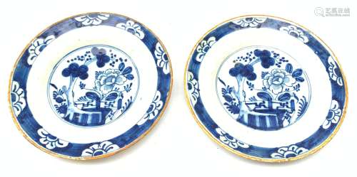 A pair of late 18th century/early 19th century blue and white Delft plates, of circular form decorat