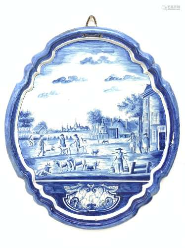 A late 19th century/early 20th century Dutch Deltware blue and white wall plaque, of oval form decor