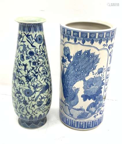A Chinese blue and white umbrella stand, of cylindrical form decorated with birds perched upon bloss