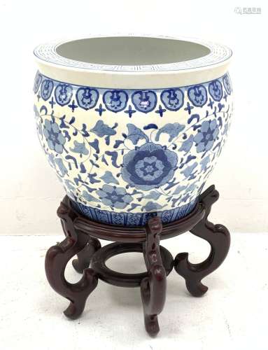 A large Chinese blue and white jardini�re decorated with a band of flowers and tendrils within styli