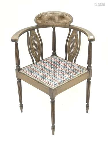 Edwardian mahogany corner chair, cane panelled back with reeded supports, upholstered seat, W59cm