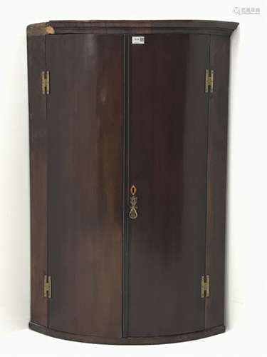 George III mahogany bow corner cabinet, two doors enclosing three shelves, W74cm, H107cm