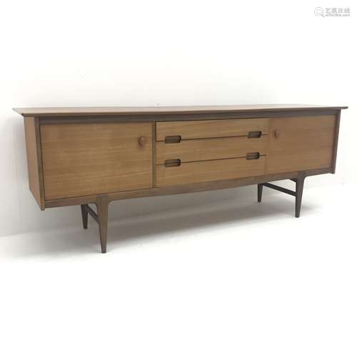 Mid 20th century Younger teak sideboard, two cupboards flanking three graduating drawers on tapering