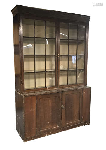 Early 19th century stained pine bookcase on cupboard, fitted with two astragal glazed doors above tw