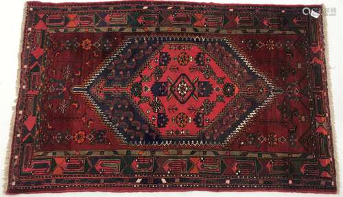 Afghan hand knotted red ground rug, diamond centre with geometric pattern, 195cm x 122cm